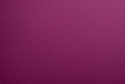 The primary subject of the image is a large, purple wall. The setting is a room with a pink background. The visual style is a close-up of the wall, which gives a sense of depth and texture. The dominant colors are purple and pink, creating a warm and inviting atmosphere.
