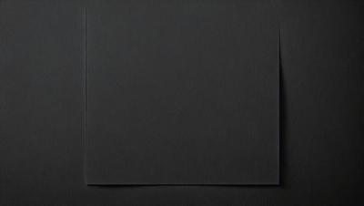 The primary subject of the image is a black square, which is the main object, scene, or focus of the image. The setting or background is a black surface, and the visual style is a black and white photo. The colors and mood of the image are predominantly dark and moody, with the black square being the main point of interest.