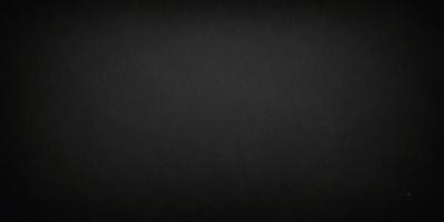 The image is a black and white photo of a dark background.