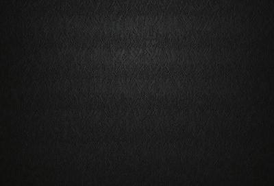 The primary subject of the image is a black leather material, which appears to be a leather-like fabric or a leather-like wallpaper. The setting is a black background, which contrasts with the leather material. The visual style is a close-up of the leather material, showcasing its texture and appearance. The colors and mood of the image are predominantly black, giving it a sleek and modern look.