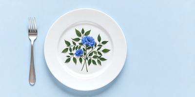 The primary subject of the image is a white plate with a blue flower design on it. The plate is placed on a blue surface, which adds a contrasting color to the scene. The visual style of the image is a combination of photo and digital art, creating a realistic yet artistic representation of the flower design. The dominant colors in the image are white and blue, giving the scene a clean and calming atmosphere.