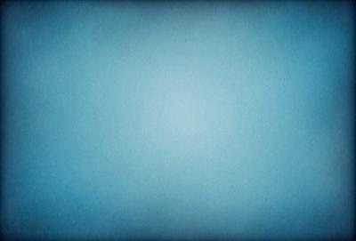 The primary subject of the image is a large, empty blue sky. The setting is a vast, open space with no visible landmarks or objects. The visual style is a natural, untouched landscape. The colors and mood are predominantly blue, creating a serene and peaceful atmosphere.