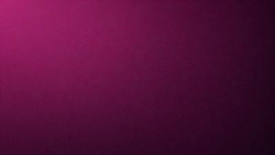 The primary subject of the image is a large, purple wall. The setting is a room with a pink background. The visual style is a close-up of the wall, which gives a sense of depth and texture. The dominant colors are purple and pink, creating a warm and inviting atmosphere.