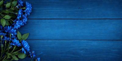 The primary subject of the image is a blue wooden surface with a flower pattern. The setting is a wooden wall, and the visual style is a photo. The dominant colors are blue and white, creating a calm and serene atmosphere.