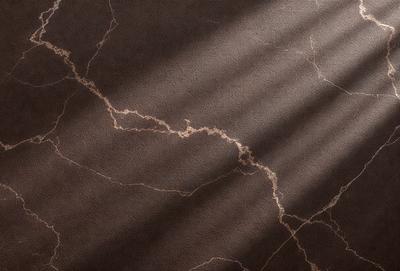 The primary subject of the image is a marble floor with a cracked pattern. The setting is a room with a brown carpet, and the visual style is a photo. The colors and mood of the image are dark and moody, with the marble floor and cracked pattern creating a sense of unease or tension.