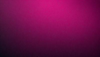 The primary subject of the image is a close-up of a pink carpet. The setting is a room with a pink carpet covering the floor. The visual style is a photo, and the dominant colors are pink and purple, creating a warm and inviting atmosphere.