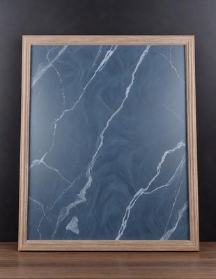 The primary subject of the image is a marble-patterned picture frame. The setting is a dark background, which contrasts with the light blue marble pattern. The visual style is a combination of a photo and a digital art, as the marble pattern appears to be a digital design. The colors and mood of the image are predominantly dark and moody, with the blue marble pattern providing a touch of brightness and elegance.