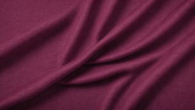 The primary subject of the image is a piece of red fabric, which is the main object, scene, or focus of the image. The setting or background of the image is a purple cloth, which is visible in the background. The visual style of the image is a close-up of the red fabric, showcasing its texture and details. The dominant colors in the image are red and purple, creating a warm and vibrant atmosphere.