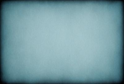 The primary subject of the image is a large, blue sheet of paper. The setting is a blank, blue background, which creates a clean and uncluttered visual style. The colors and mood of the image are predominantly blue, giving it a calm and serene atmosphere.