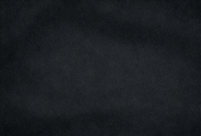 The primary subject of the image is a black background with a texture that resembles a woven fabric. The setting is a dark room, and the visual style appears to be a close-up of the fabric. The colors and mood of the image are predominantly dark and moody, with the black background and the woven fabric creating a sense of depth and intrigue.