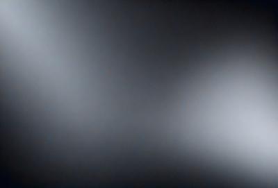The primary subject of the image is a black and white photo of a dark room. The setting is a dark room with a black background, and the visual style is a black and white photo. The colors and mood of the image are predominantly dark and moody, creating a sense of mystery and intrigue.