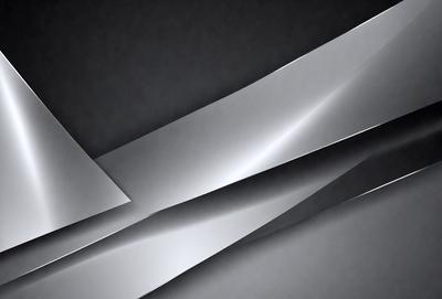 The primary subject of the image is a silver metal sheet, which is the main object, scene, or focus of the image. The setting or background is a dark, possibly black, surface, which contrasts with the silver metal sheet. The visual style of the image is a close-up of the metal sheet, showcasing its texture and details. The colors and mood of the image are predominantly silver and dark, creating a sense of depth and contrast.