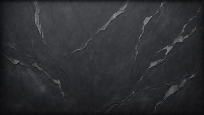 The primary subject of the image is a black marble surface with a pattern of holes and cracks. The setting is a dark room, and the visual style is a close-up of the marble surface. The colors and mood of the image are dark and moody, with the black marble surface being the dominant color.