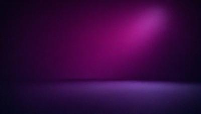 The primary subject of the image is a purple wall with a bright light shining on it. The setting is a room with a purple background, and the visual style appears to be a photo. The dominant colors in the image are purple and pink, creating a warm and inviting atmosphere.
