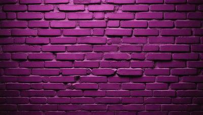 The primary subject of the image is a purple brick wall. The setting is a brick wall with a purple color, and the visual style is a close-up of the wall. The dominant colors and overall atmosphere of the image are purple and brick-like, creating a unique and visually striking scene.