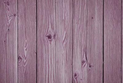 The primary subject of the image is a wooden surface with a purple tint. The setting is a wooden wall, and the visual style is a close-up of the wooden surface. The colors and mood of the image are predominantly purple, giving it a unique and artistic appearance.