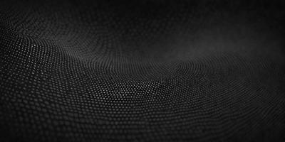 The primary subject of the image is a close-up of a black fabric with a pattern of small white dots. The setting is a dark background, which contrasts with the fabric. The visual style appears to be a photo, as the dots are clearly visible and the fabric appears to be textured. The colors and mood of the image are predominantly dark, with the white dots providing a subtle contrast against the black fabric.