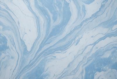 The primary subject of the image is a blue and white marbled wallpaper. The setting is a room with a blue and white marbled wallpapered wall. The visual style is a close-up of the wallpaper, showcasing its intricate design. The colors and mood of the image are predominantly blue and white, creating a calm and elegant atmosphere.