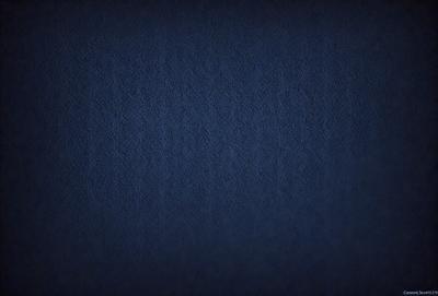 The primary subject of the image is a blue fabric, which appears to be a piece of denim. The setting is a dark room, and the visual style is a close-up of the fabric. The colors and mood of the image are predominantly dark and moody, with the blue fabric being the main focus.