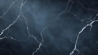The primary subject of the image is a close-up of a black and white marble wall with a cracked texture. The setting is a dark room, and the visual style is a black and white photo. The dominant colors are black and white, and the overall atmosphere is dramatic and moody.