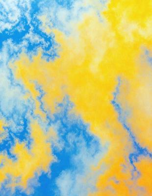 The primary subject of the image is a cloudy sky with a yellowish hue. The setting is a blue sky, and the visual style appears to be a photo. The dominant colors are yellow and blue, creating a warm and serene atmosphere.