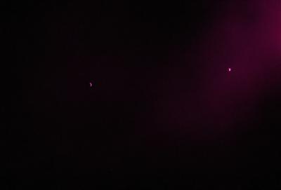 The image is a black and white photo of a night sky. The primary subject is the moon, which is visible in the sky. The setting is a dark, starry night with a few stars scattered throughout the sky. The visual style is a classic black and white photo, giving it a timeless and nostalgic feel. The colors and mood are predominantly dark and moody, with the moon being the only source of light in the scene.