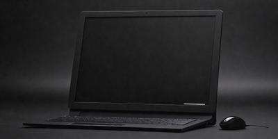 The primary subject of the image is a laptop computer. The laptop is sitting on a black surface, which could be a table or a desk. The visual style of the image is a photo, capturing the laptop in a close-up view. The colors and mood of the image are dark and moody, with the laptop being the main focus of the scene.