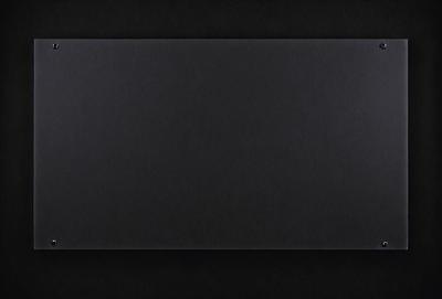 The primary subject of the image is a black background. The setting is a dark room, and the visual style is a black and white photo. The colors and mood of the image are predominantly dark and moody.