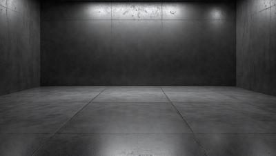 The primary subject of the image is a large, empty room with a black wall. The setting is a dark, empty space, and the visual style is a black and white photo. The room appears to be a warehouse or a storage area, with a concrete floor and a cement wall. The overall atmosphere is one of emptiness and darkness.