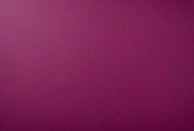 The primary subject of the image is a large, pink wall. The setting is a room with a purple background. The visual style is a close-up of the wall, which gives a sense of depth and texture. The colors and mood of the image are predominantly purple, creating a calm and serene atmosphere.