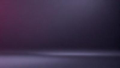 The primary subject of the image is a purple background with a dark, moody atmosphere. The setting is a dark room, and the visual style appears to be a photo. The colors and mood of the image are predominantly purple, creating a sense of mystery and depth.