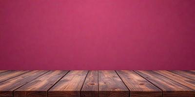 The primary subject of the image is a wooden table with a pink wall in the background. The table appears to be a dining table, and the pink wall adds a vibrant and warm atmosphere to the scene. The visual style of the image is a photo, capturing the wooden table and the pink wall in a realistic manner. The colors and mood of the image are predominantly pink, creating a sense of warmth and comfort.