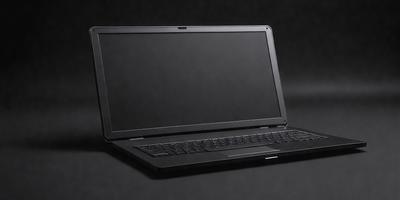 The primary subject of the image is a laptop computer. The laptop is sitting on a black surface, which could be a table or a desk. The visual style of the image is a photo, capturing the laptop in a close-up view. The colors and mood of the image are dark and moody, with the black laptop and the black surface creating a sense of depth and contrast.