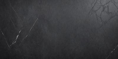 The primary subject of the image is a black leather surface, which appears to be a leather wall or a leather-like material. The setting is a black background, which contrasts with the leather surface. The visual style is a close-up of the leather surface, showcasing its texture and details. The colors and mood of the image are predominantly dark and moody, with the black leather surface being the main focus.