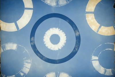 The primary subject of the image is a large, round, white cloud in a blue sky. The cloud is surrounded by a circle, which is also blue. The setting is a clear, cloudless sky, and the visual style appears to be a combination of a photo and a digital art or illustration. The colors are predominantly blue, with the white cloud standing out against the blue sky. The overall atmosphere is serene and peaceful.