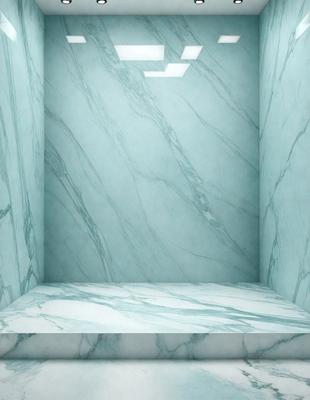 The primary subject of the image is a marble countertop with a blue tint. The setting is a room with a blue wall, and the visual style is a photo. The countertop has a marble texture, and the overall atmosphere is calm and sophisticated.