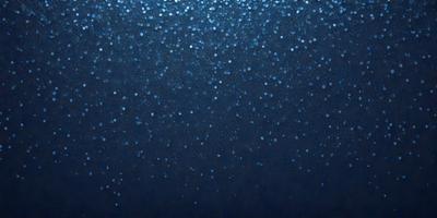 The primary subject of the image is a blue background with a pattern of blue dots. The setting is a dark, starry night, with the dots creating a celestial atmosphere. The visual style is a digital art, as the dots are arranged in a visually appealing manner. The colors and mood are predominantly blue, creating a serene and peaceful ambiance.