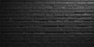 The primary subject of the image is a black brick wall. The setting is a brick wall, and the visual style is a photo. The dominant colors are black and grey, creating a moody atmosphere.