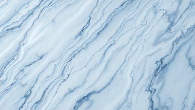 The primary subject of the image is a marble countertop with a blue and white pattern. The setting is a kitchen or bathroom, as the countertop is a common feature in these spaces. The visual style is a close-up of the marble countertop, showcasing its intricate design. The colors and mood of the image are predominantly blue and white, giving it a clean and elegant appearance.