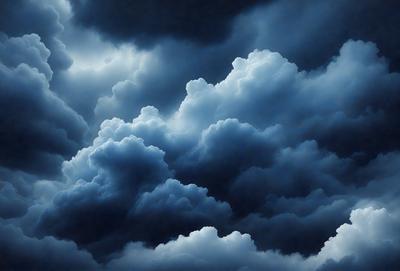 The primary subject of the image is a cloudy sky with dark clouds and a blue background. The setting is an outdoor environment, possibly during a storm. The visual style is a photo of the cloudy sky, capturing the beauty and intensity of the clouds. The colors and mood of the image are dark and moody, with the clouds creating a dramatic and ominous atmosphere.
