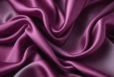 The primary subject of the image is a purple fabric, which is the main object, scene, or focus of the image. The setting/background consists of a purple sheet, and the visual style is a close-up of the fabric. The colors and mood of the image are predominantly purple, creating a calm and serene atmosphere.