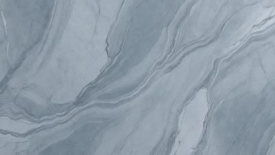 The primary subject of the image is a marble countertop with a patterned design. The setting is a kitchen, and the visual style is a close-up of the countertop. The colors and mood of the image are predominantly gray, giving it a sophisticated and elegant appearance.