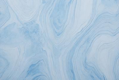The primary subject of the image is a blue and white marbled wallpaper. The setting is a room with a blue and white marbled wallpapered wall. The visual style is a close-up of the wallpaper, showcasing its intricate design. The colors and mood of the image are predominantly blue and white, creating a calm and elegant atmosphere.