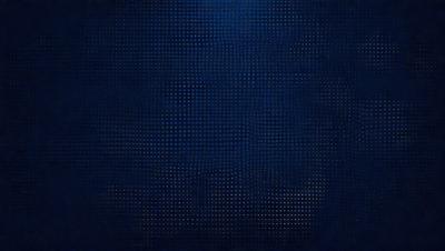 The primary subject of the image is a blue background with a pattern of small dots. The setting appears to be a dark room, and the visual style is a close-up of the blue background. The colors and mood of the image are predominantly dark and moody, with the blue background providing a sense of depth and contrast.