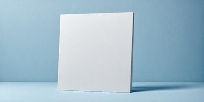 The primary subject of the image is a white cardboard box. The setting is a blue background, which creates a contrasting and visually appealing scene. The visual style is a photo, capturing the details of the cardboard box. The colors and mood of the image are predominantly blue, giving it a calm and serene atmosphere.