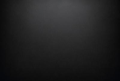The primary subject of the image is a black background with a white dot in the center. The setting is a dark room, and the visual style is a simple, minimalist design. The colors and mood are predominantly dark and moody, with the white dot providing a contrasting element.
