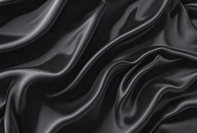 The primary subject of the image is a close-up of a black, shiny, and textured surface. The setting appears to be a dark room, with the surface being the main focus of the image. The visual style is a close-up of a pattern, possibly a wallpaper or a textured material. The colors and mood of the image are predominantly dark and moody, with the black surface being the main element in the scene.