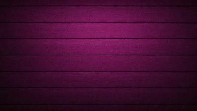 The primary subject of the image is a purple wall. The setting is a room with a purple wall, and the visual style is a close-up of the wall. The colors and mood of the image are predominantly purple, creating a calm and serene atmosphere.