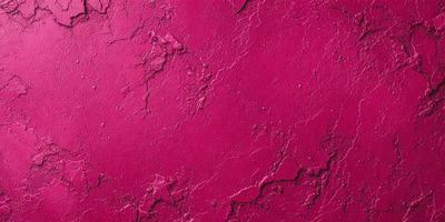 The primary subject of the image is a close-up of a red wall with a pinkish hue. The setting is a room with a red wall, and the visual style appears to be a photo. The dominant colors in the image are red and pink, creating a warm and inviting atmosphere.