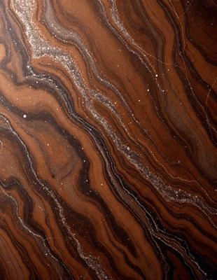 The primary subject of the image is a close-up of a marbled stone surface. The setting is a dark room, and the visual style appears to be a photo. The colors and mood of the image are dark and moody, with the marbled stone surface being the main focus.